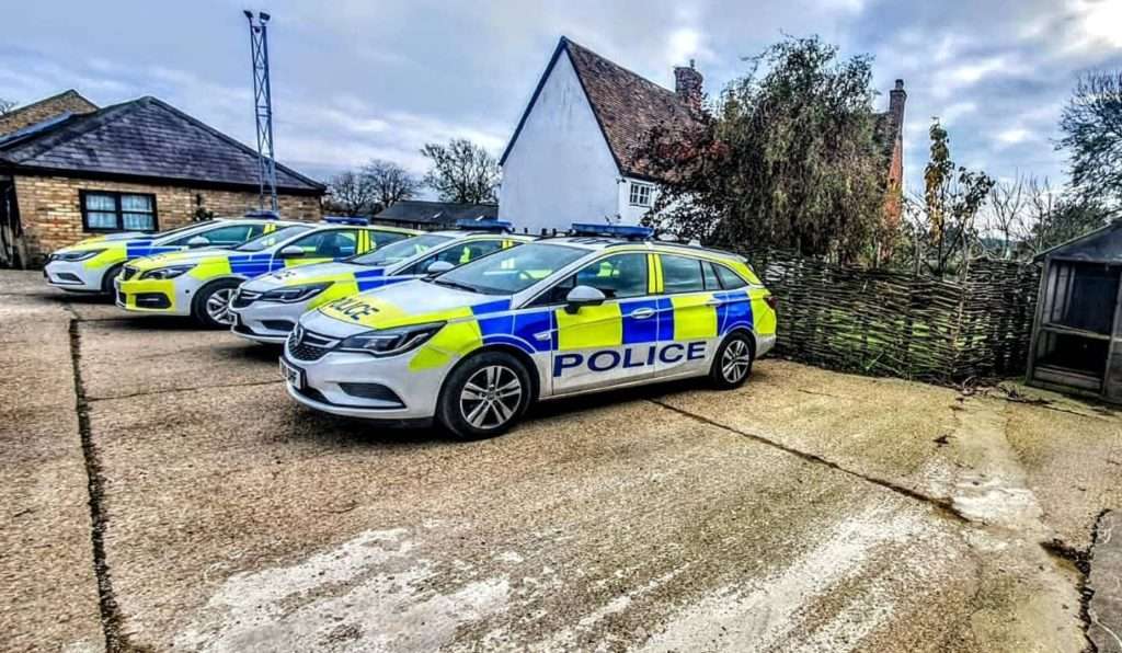 Police cars parked at rural crime event